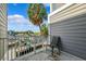 Balcony with views of water and palm trees, featuring a single patio chair at 5712 Biscayne Ct # 103, New Port Richey, FL 34652