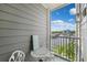Balcony with a small table and chairs offering beautiful views of the water and marina at 5712 Biscayne Ct # 103, New Port Richey, FL 34652
