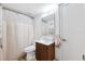 Cozy bathroom featuring a modern vanity and mirror, complemented by a shower with a patterned curtain at 5712 Biscayne Ct # 103, New Port Richey, FL 34652
