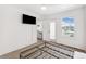 Bedroom with mounted TV and view to the living area and the water from the window at 5712 Biscayne Ct # 103, New Port Richey, FL 34652