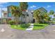 Charming two-story condo building with lush landscaping and well-maintained grounds featuring mature palm trees at 5712 Biscayne Ct # 103, New Port Richey, FL 34652