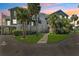 Attractive condo building with mature palms and walkway at 5712 Biscayne Ct # 103, New Port Richey, FL 34652