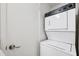 The compact laundry space features a stacked washer and dryer at 5712 Biscayne Ct # 103, New Port Richey, FL 34652