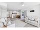 Open-concept living area with combined living and dining area and white kitchen with breakfast bar at 5712 Biscayne Ct # 103, New Port Richey, FL 34652