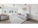 Inviting living area features a neutral palette, plush seating, and natural light from large windows with water views at 5712 Biscayne Ct # 103, New Port Richey, FL 34652