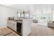 Bright open-concept living space adjacent to kitchen with balcony access at 5712 Biscayne Ct # 103, New Port Richey, FL 34652