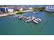 Scenic aerial view of a private boat dock with multiple slips and various watercraft at 6020 Shore S Blvd # 503, Gulfport, FL 33707