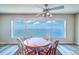 A cozy dining area showcases a large window with scenic water views and a ceiling fan at 6020 Shore S Blvd # 503, Gulfport, FL 33707