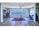 Bright dining area with hardwood floors, ceiling fan, and a large window offering a picturesque view at 6020 Shore S Blvd # 503, Gulfport, FL 33707