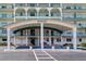 Beautiful entrance to Windsor building, with covered parking, walkway, and well manicured plants at 6020 Shore S Blvd # 503, Gulfport, FL 33707