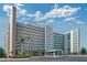 A stunning multi-story condominium building with architectural features and a professionally landscaped parking area at 6020 Shore S Blvd # 503, Gulfport, FL 33707