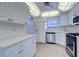 White kitchen with white appliances and tile backsplash at 6020 Shore S Blvd # 503, Gulfport, FL 33707