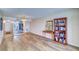 Spacious living area with hardwood floors, stylish furniture, and beautiful decorative mirror and bookshelf at 6020 Shore S Blvd # 503, Gulfport, FL 33707