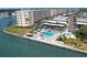 Aerial view of pool, tiki huts, lounge chairs overlooking waterfront at 6020 Shore S Blvd # 503, Gulfport, FL 33707