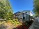 Expansive backyard featuring lush landscaping, mature trees, and a screened-in pool area at 6073 115Th N Ave, Pinellas Park, FL 33782