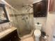 A beautifully designed bathroom, showcasing a glass shower, elegant granite countertops, and a sleek, modern sink at 6073 115Th N Ave, Pinellas Park, FL 33782