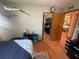 Comfortable bedroom featuring hardwood floors, a large mirror on the closet door, and decoratively arranged wall art at 6073 115Th N Ave, Pinellas Park, FL 33782