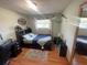 Comfortable bedroom with a window, ceiling fan, desk, dark furniture and decoratively styled furnishings and wall art at 6073 115Th N Ave, Pinellas Park, FL 33782