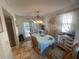 Dining room featuring an oval dining table, bright light fixture, and an adjacent outdoor deck at 6073 115Th N Ave, Pinellas Park, FL 33782