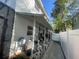 Home exterior with white siding, a covered patio, and a white fence along the property line at 6073 115Th N Ave, Pinellas Park, FL 33782
