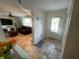 Inviting foyer with tile flooring, a decorative front door, and a view into the living room at 6073 115Th N Ave, Pinellas Park, FL 33782