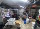 A messy garage with tool, motorcycle parts, boxes and a work area at 6073 115Th N Ave, Pinellas Park, FL 33782