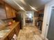 Traditional kitchen featuring stone tile flooring, stainless steel appliances, and wood cabinetry at 6073 115Th N Ave, Pinellas Park, FL 33782