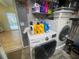 A well lit laundry room with a LG washer and dryer with shelving and view to pool at 6073 115Th N Ave, Pinellas Park, FL 33782