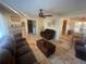 Open concept living room with a fireplace, comfortable seating, and a view into the dining area at 6073 115Th N Ave, Pinellas Park, FL 33782