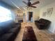 Cozy living room with a fireplace, comfortable sofas, and tiled flooring at 6073 115Th N Ave, Pinellas Park, FL 33782