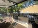 Outdoor kitchen features a grill, sink, and bar seating area on a wooden deck beneath a covered patio at 6073 115Th N Ave, Pinellas Park, FL 33782