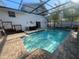 Inviting in-ground pool with a screened enclosure and a deck area for outdoor enjoyment at 6073 115Th N Ave, Pinellas Park, FL 33782