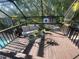 Screened patio features seating and a table overlooking a lush backyard setting at 6073 115Th N Ave, Pinellas Park, FL 33782