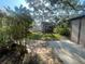 Backyard shed with landscaping, a stone path and concrete driveway at 6073 115Th N Ave, Pinellas Park, FL 33782