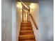 Elegant staircase with wood steps and handrail, leading to an upstairs hallway featuring recessed lighting and wall decor at 6073 115Th N Ave, Pinellas Park, FL 33782