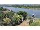 Aerial view showcasing the waterfront home with private dock and lush landscaping on the Palm River at 6610 Myrna Dr, Tampa, FL 33619