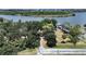 Aerial view of a property with tree-lined drive near a body of water, and a boat dock at 6610 Myrna Dr, Tampa, FL 33619