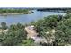 Waterfront home surrounded by mature trees, offering privacy and beautiful views of the Palm River at 6610 Myrna Dr, Tampa, FL 33619
