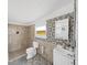 Bathroom featuring tiled shower, mosaic accent wall, and updated fixtures at 6610 Myrna Dr, Tampa, FL 33619