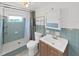 Bathroom featuring tiled shower, a light blue tiled walls, and updated fixtures at 6610 Myrna Dr, Tampa, FL 33619