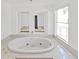 Spacious bathroom with a large soaking tub and large window at 6610 Myrna Dr, Tampa, FL 33619
