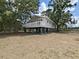 Charming raised home with a wraparound deck and ample shaded outdoor space at 6610 Myrna Dr, Tampa, FL 33619