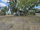 Exterior angle of waterfront home situated on a large lot with beautiful trees at 6610 Myrna Dr, Tampa, FL 33619