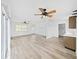 Bright living room featuring modern flooring, ceiling fans and natural light at 6610 Myrna Dr, Tampa, FL 33619
