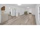 Open-concept living room features new flooring and views into kitchen and other rooms at 6610 Myrna Dr, Tampa, FL 33619