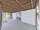 View of covered porch with latticework ceiling, white walls, screen and sliding glass doors at 6610 Myrna Dr, Tampa, FL 33619