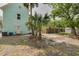 The backyard features lush trees, and space for a basketball court and shed at 6904 S Fitzgerald St, Tampa, FL 33616