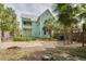 Backyard features mature trees, a metal roof, landscaping, and brick pavers at 6904 S Fitzgerald St, Tampa, FL 33616