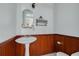 Classic bathroom with pedestal sink, wood paneling and decorative elements at 6904 S Fitzgerald St, Tampa, FL 33616