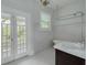 Bathroom features traditional tile, a vintage-style chandelier and access to a porch at 6904 S Fitzgerald St, Tampa, FL 33616